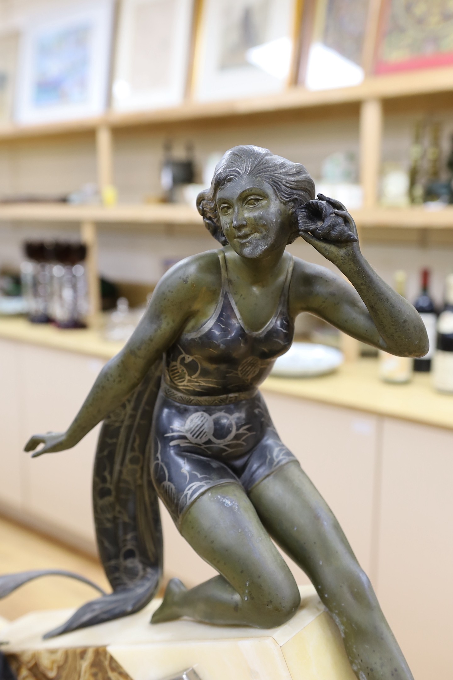 A large Art Deco spelter and marble clock garniture with a figural seaside mount, 59cm tall